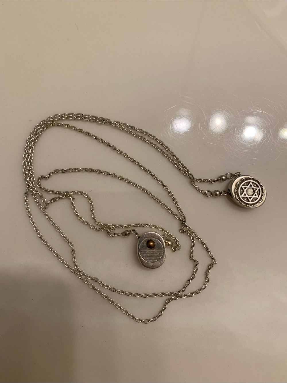 Layered Silver Pendant Necklace with Star Motif and Gold Accent
